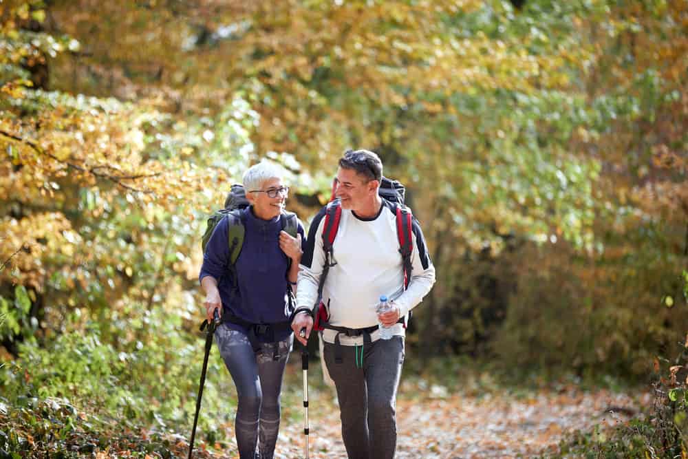 Cheerful,Elder,Couple,Hiking,In,Forest